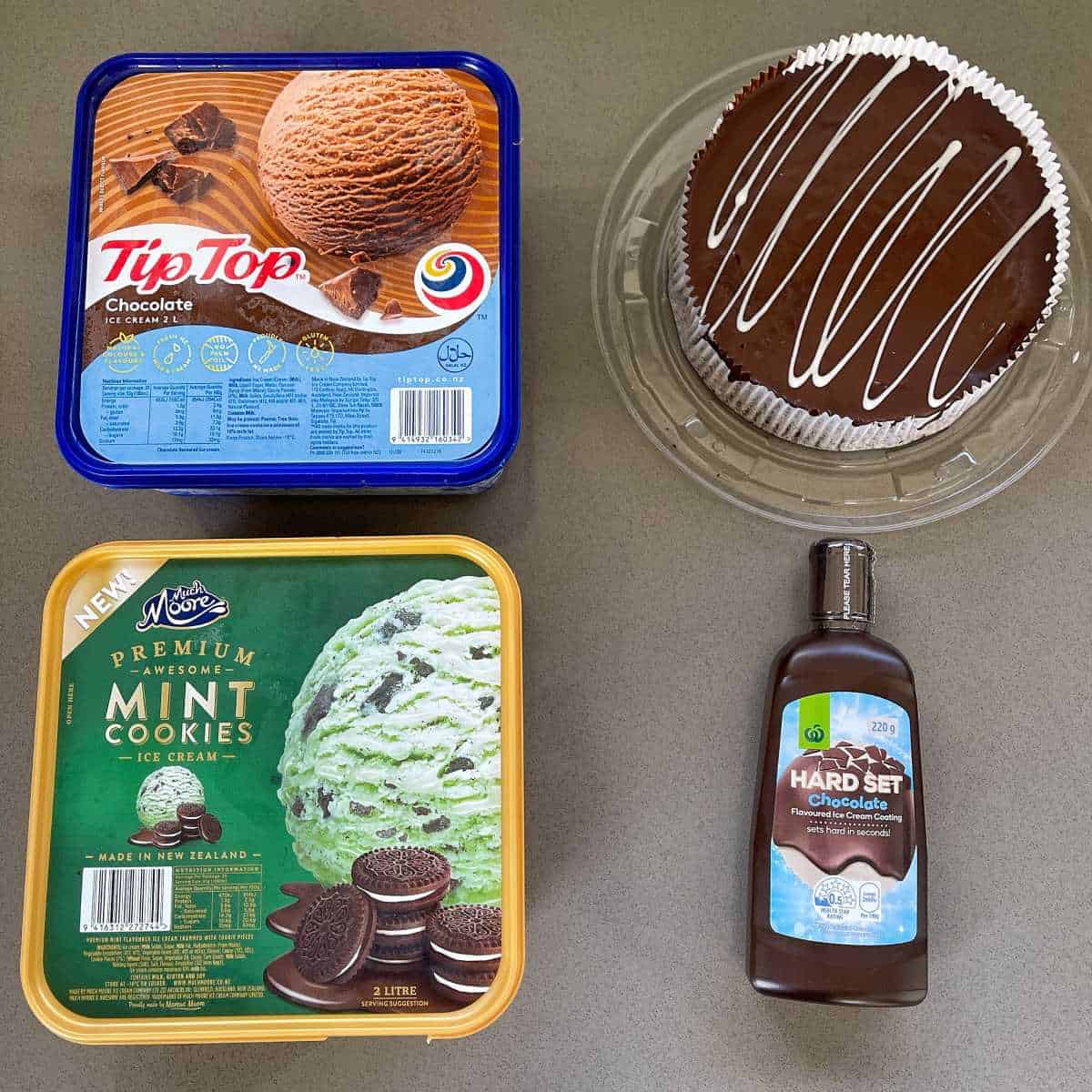 The ingredients for ice cream cake on a grey bench.