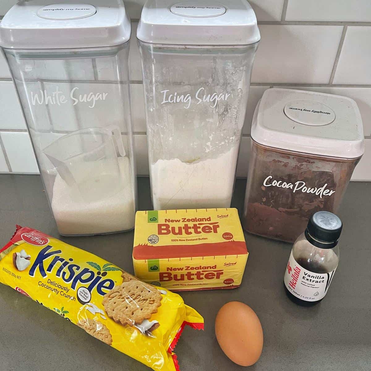 The ingredients for Krispie cake on a grey bench.