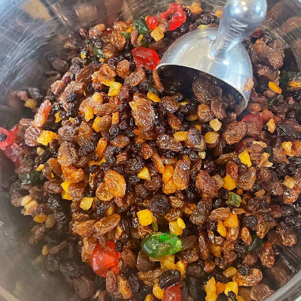 The fruit mix for Christmas cake in a glass bowl.