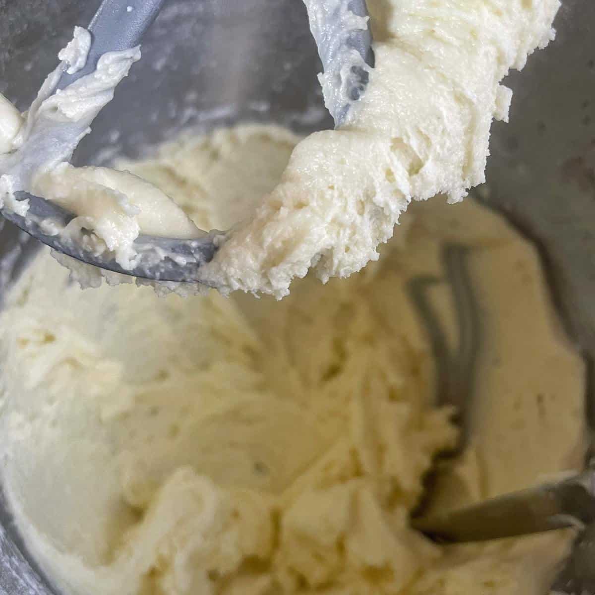 White butter icing in a cake mixing bowl.