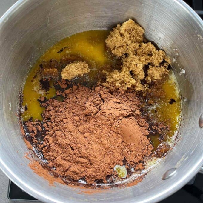 Melted butter, cocoa and brown sugar in a pot.