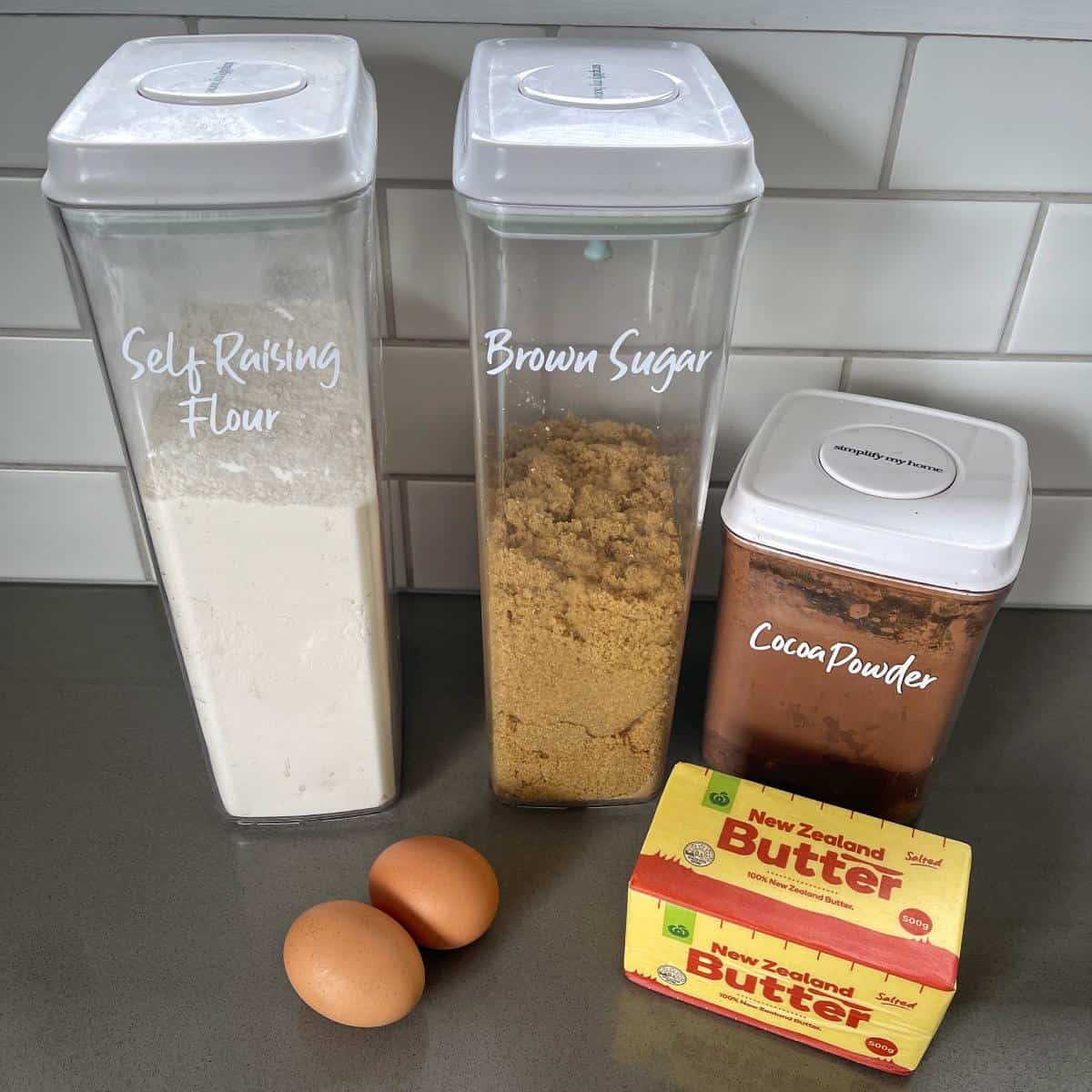 The ingredients for brownies on a grey bench.