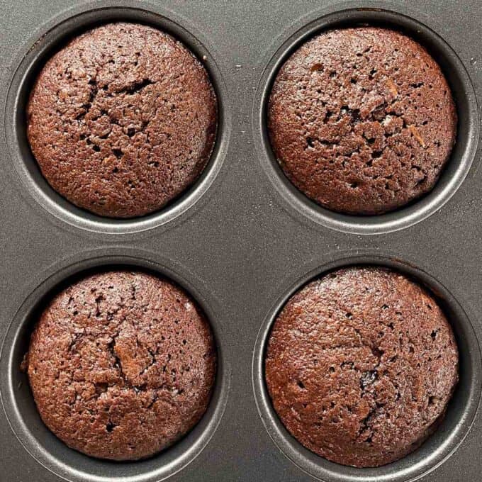 Cooked brownies in a muffin tin.