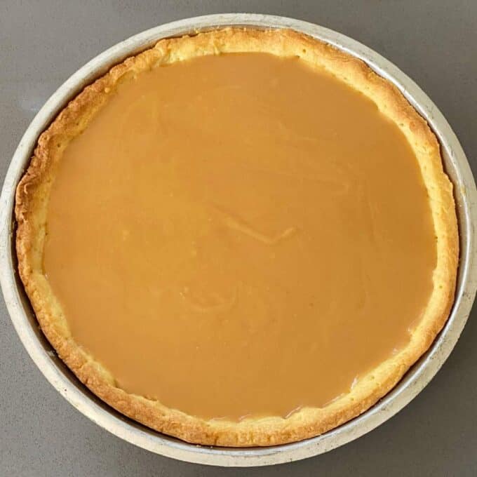 A shot of the Banoffee Pie filled with the caramel filling sitting on a grey bench top