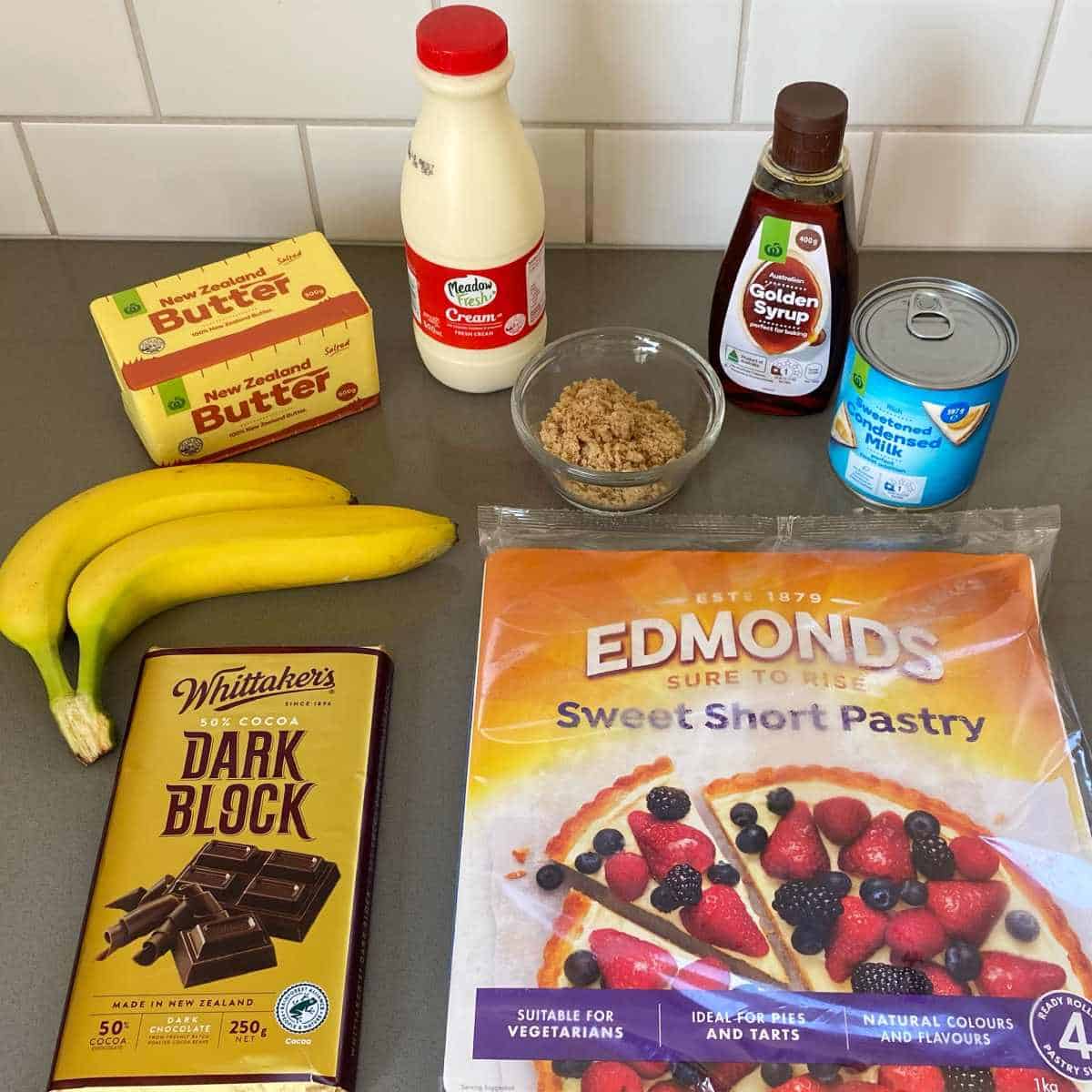 The ingredients to make Banoffee Pie on a grey bench top