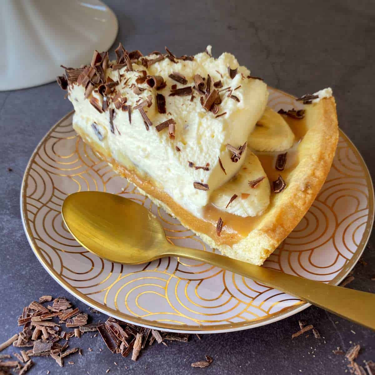 A close up shot of Banoffee Pie showing the caramel, banana and cream layers.