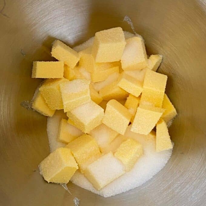 Cubbed butter and white sugar in a cake mixing bowl