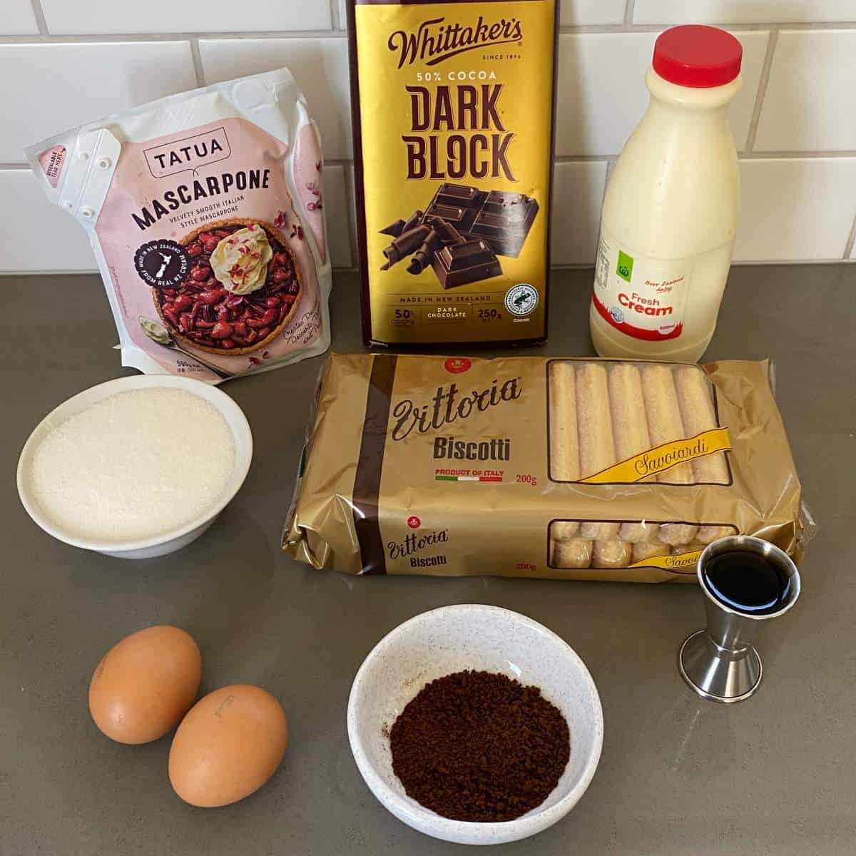 The ingredients to make individual tiramisu on a grey bench top