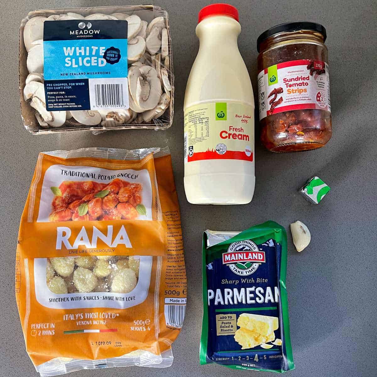 The ingredients to make mushroom gnocchi on a grey bench top