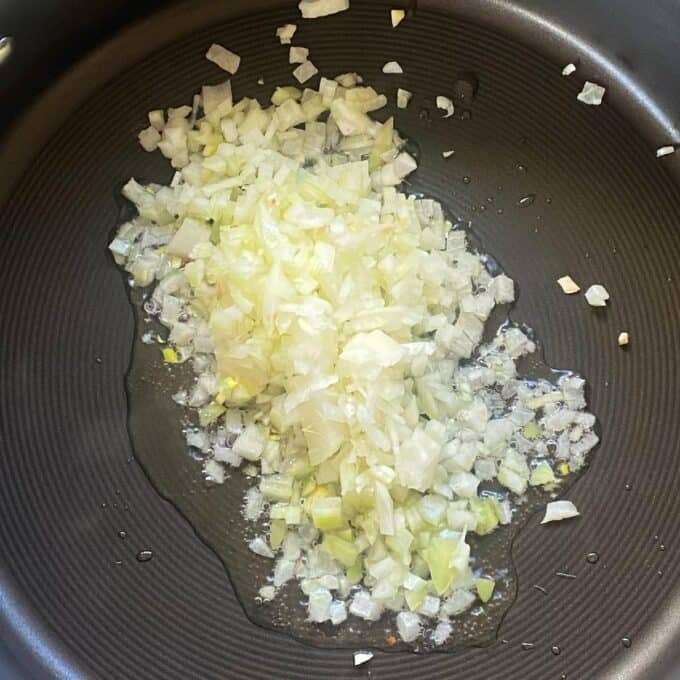 Chopped onion frying in a frypan