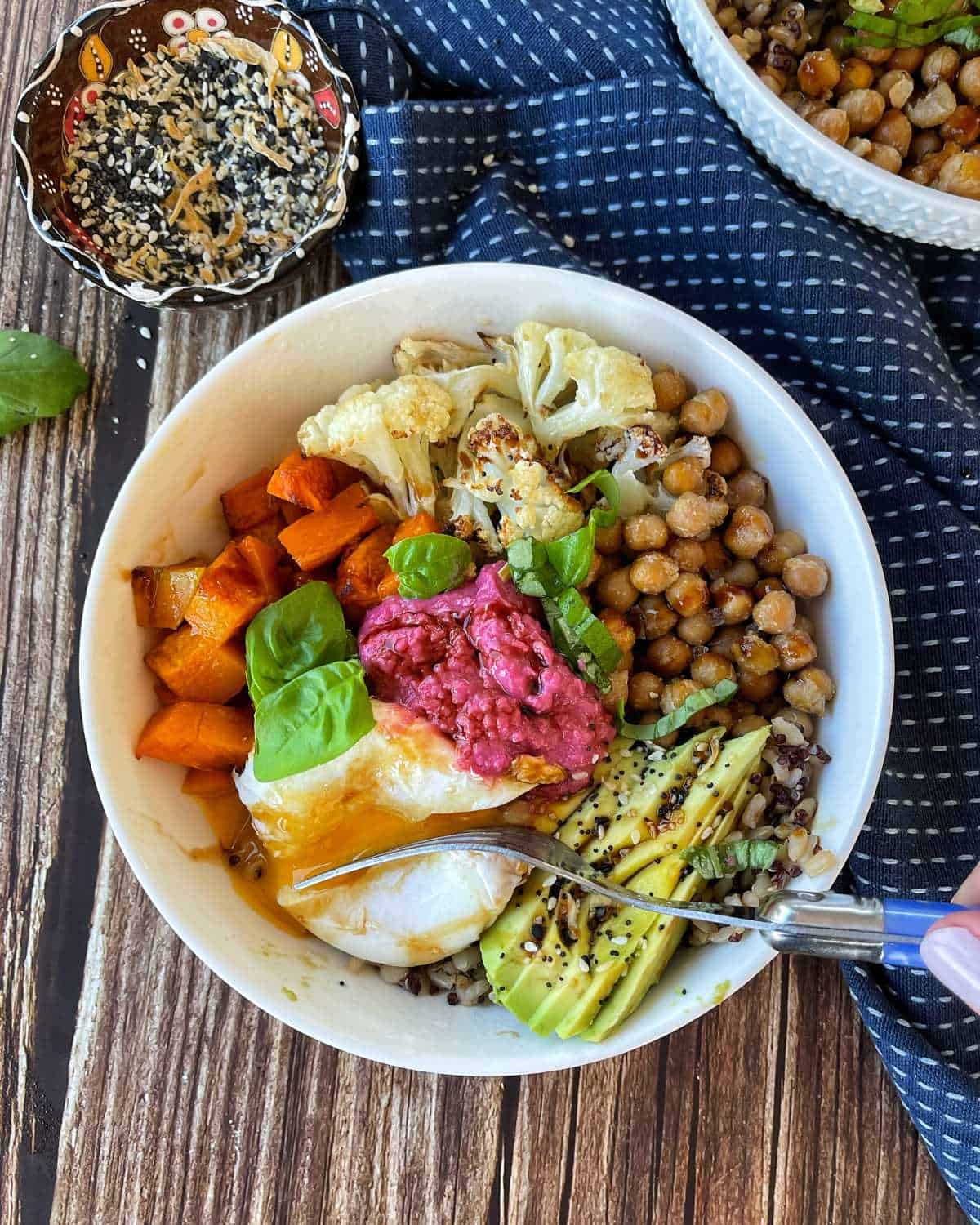 Bird's eye view of a nourish bowl on a blue napkin.