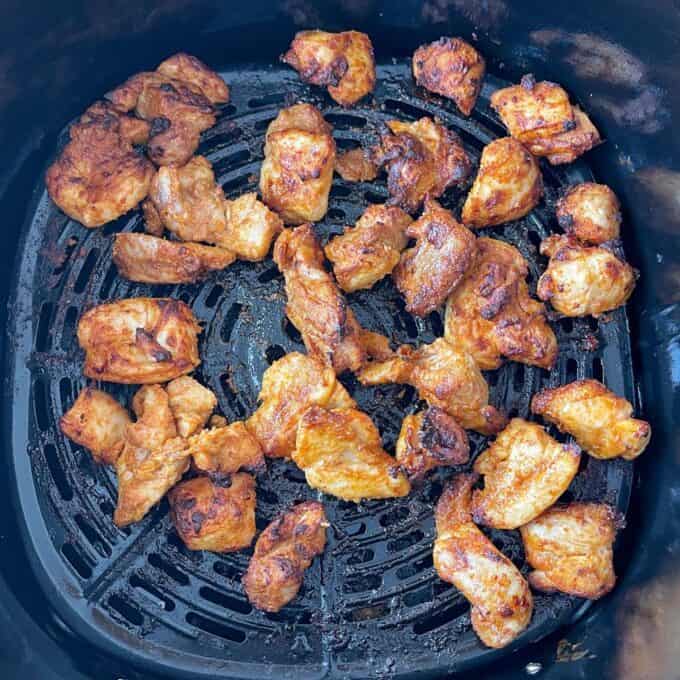 Cooked marinated chicken pieces in a air fryer
