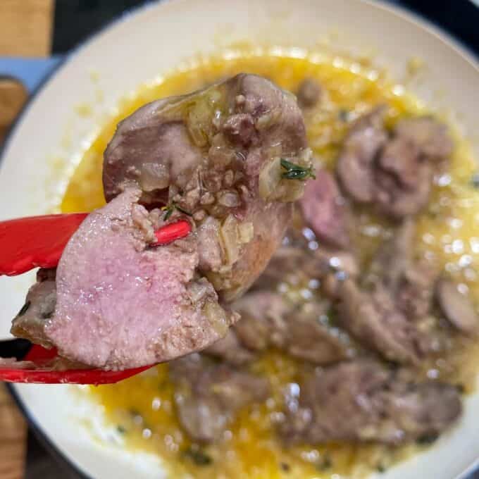 A close up of chicken livers cooking in the butter and garlic mixture
