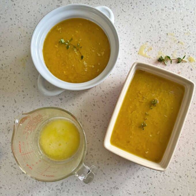 Two ramekins filled with cooked chicken liver pate and a layer of melted butter over the top to set