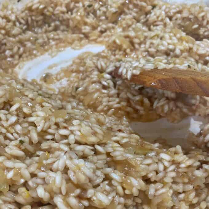 Ham and Parmesan Risotto gently cooking in a ceramic dish