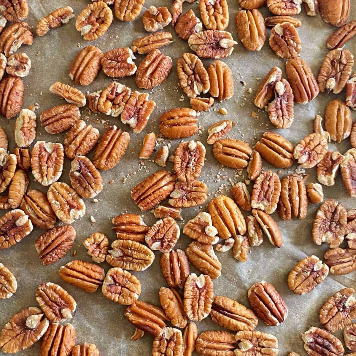 Pecan nuts on a lined baking tray