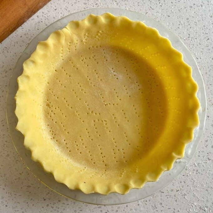 Pastry pushed into a pie tin with a few fork holes to help the pastry cook evenly