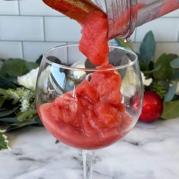 Frozen Strawberry Daquiri mixture being poured into a wine glass