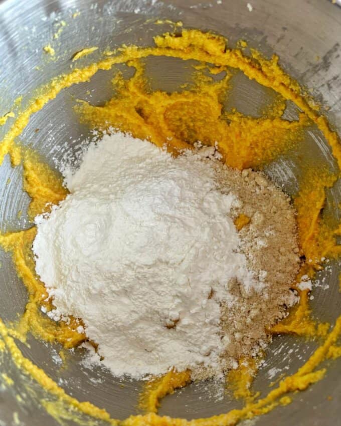 Butter egg and sugar combined  in the base of a stand mixer with almond flour and corn flour on top.
