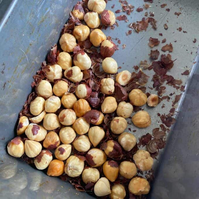 Roasted hazelnuts in a tray.