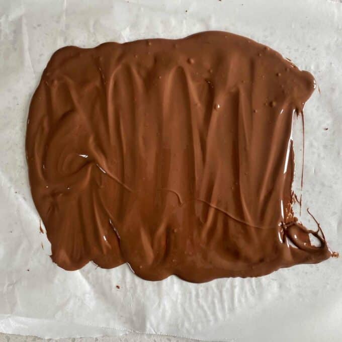 Melted chocolate on a piece of baking paper.