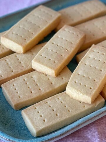 Rectangular shortbread cookies arranged on a blue ceramic plate.