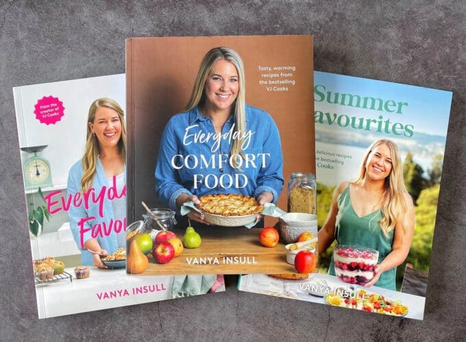 Three cookbooks by Vanya Insull are displayed on a gray surface, with Everyday Comfort Food in the center, flanked by Everyday Favourites and Summer Favourites.