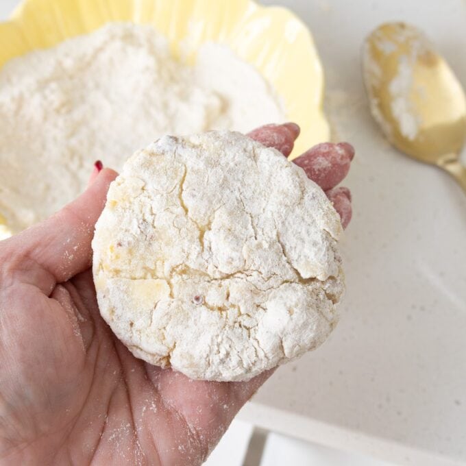 A hand holding a cookie.