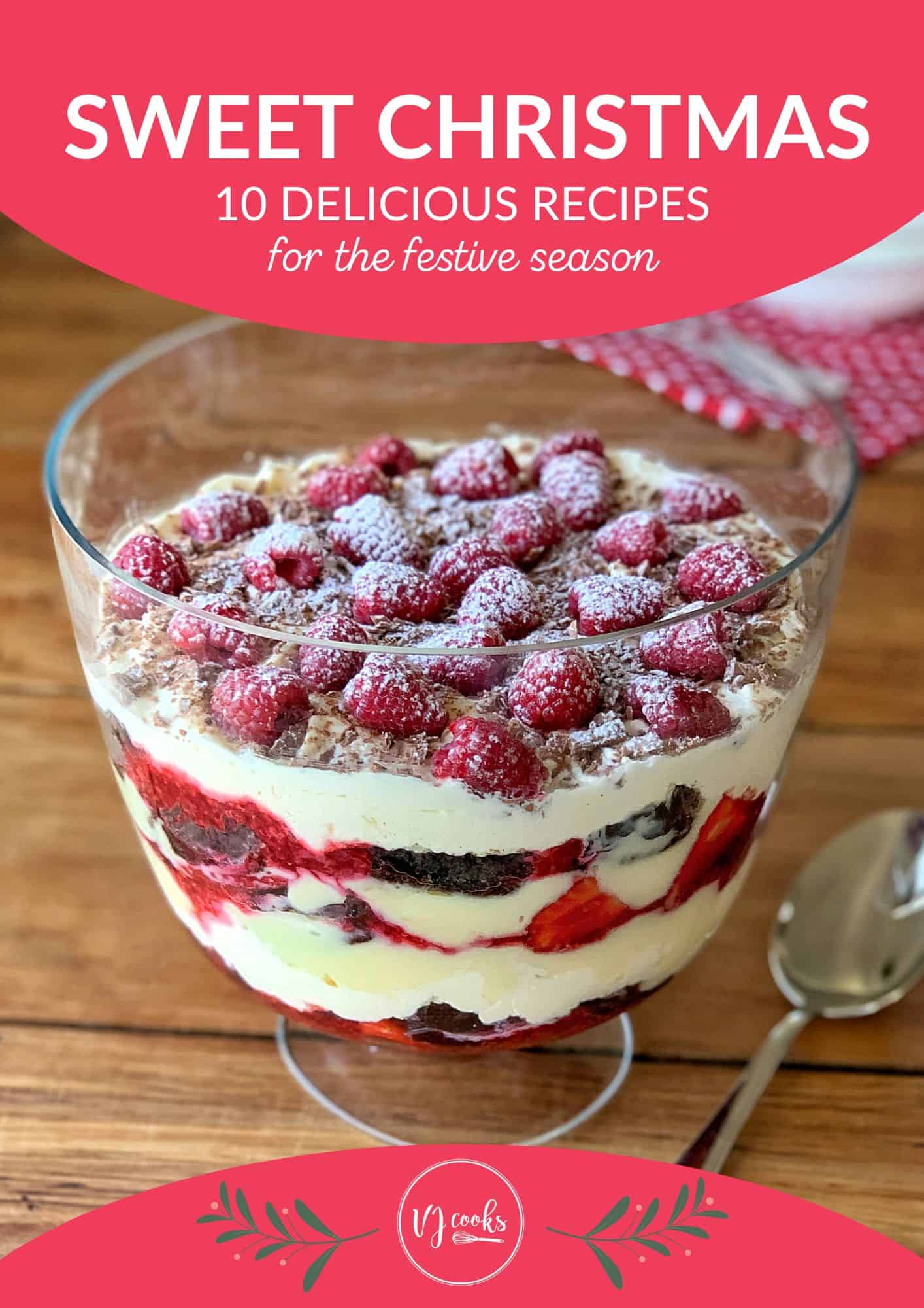 A glass trifle dish filled with layers of cream, raspberries, and cake sits on a wooden table next to a spoon, with a festive recipe banner above and below.