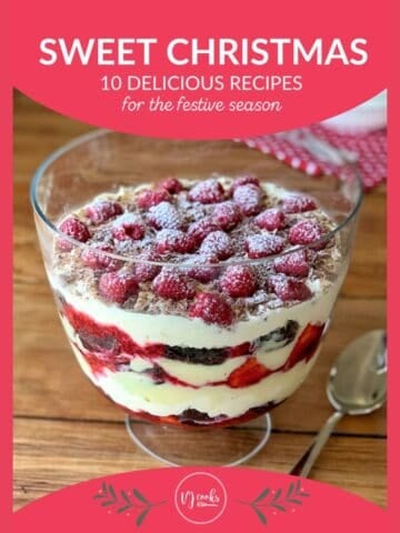 A glass trifle bowl filled with layered dessert featuring cream, chocolate, raspberries, and powdered sugar, set on a wooden table with a spoon beside it. Text reads Sweet Christmas: 10 Delicious Recipes.