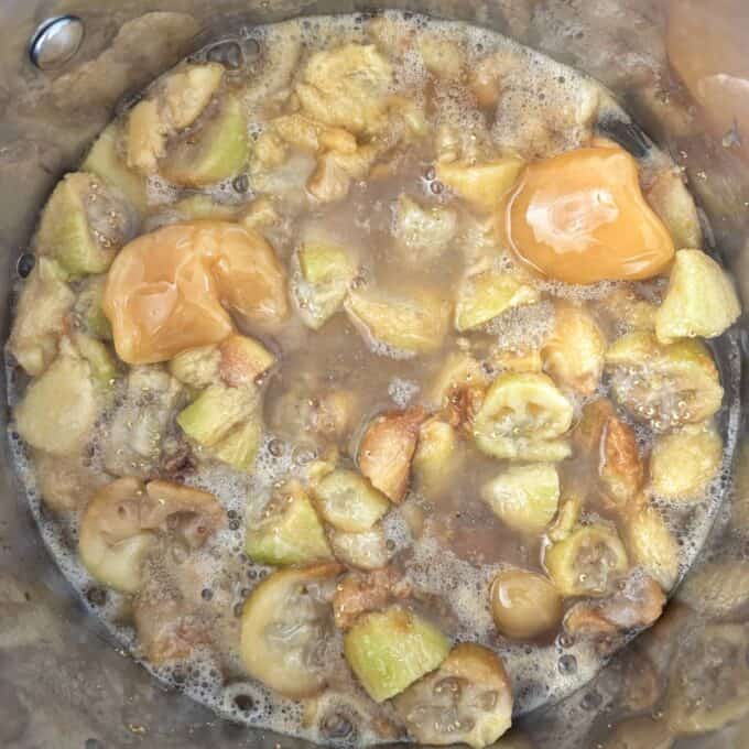 Feijoa Leather Chopped figs and brown sugar simmering in a pot, creating a bubbling mixture with visible chunks and caramelized areas.