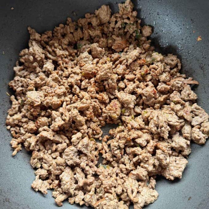 One Pot Beef Mince Noodles Cooked ground beef with seasoning in a frying pan.