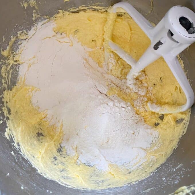 Bakewell Tart Flour sits atop creamed butter and sugar in a mixing bowl with a paddle attachment, ready to be mixed into dough.