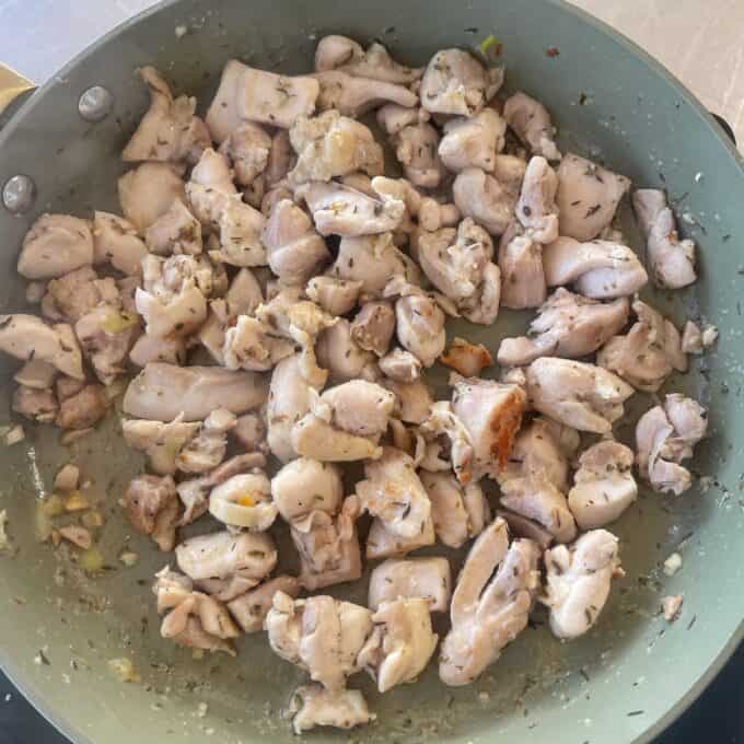 Chicken and Leek Pie Chunks of chicken seasoned with herbs and garlic are being sautéed in a nonstick skillet.