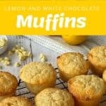 A batch of lemon and white chocolate muffins cooling on a wire rack, with baking ingredients and a labeled storage container shown in the background.