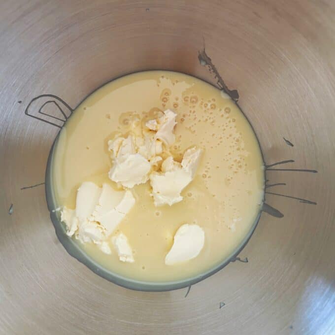 Lime Gingernut Cheesecake Butter and condensed milk in a stainless steel mixing bowl, ready to be mixed for a Lime Gingernut Cheesecake.