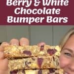 A person holds a stack of berry and white chocolate bumper bars; above are ingredients, a mixing bowl, and text reading Berry & White Chocolate Bumper Bars.