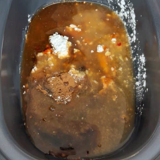 Slow Cooker Asian Style Chicken A mixture of brown liquid, seasonings, and white powder in a slow cooker, ready to be combined for cooking.
