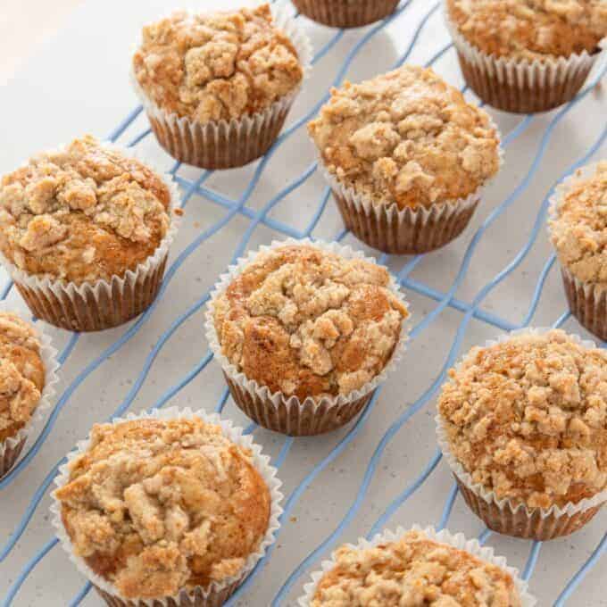 Banana Cinnamon Crumble Muffins A grid of crumb-topped muffins cooling on a wire rack.