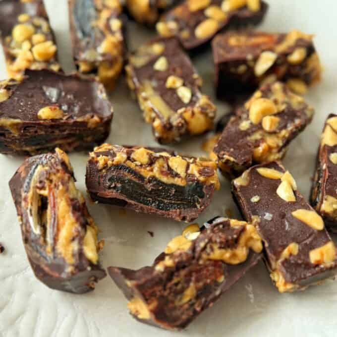 Snickers Peanut Butter Bites Pieces of dark chocolate candy filled with nuts and dried fruit.
